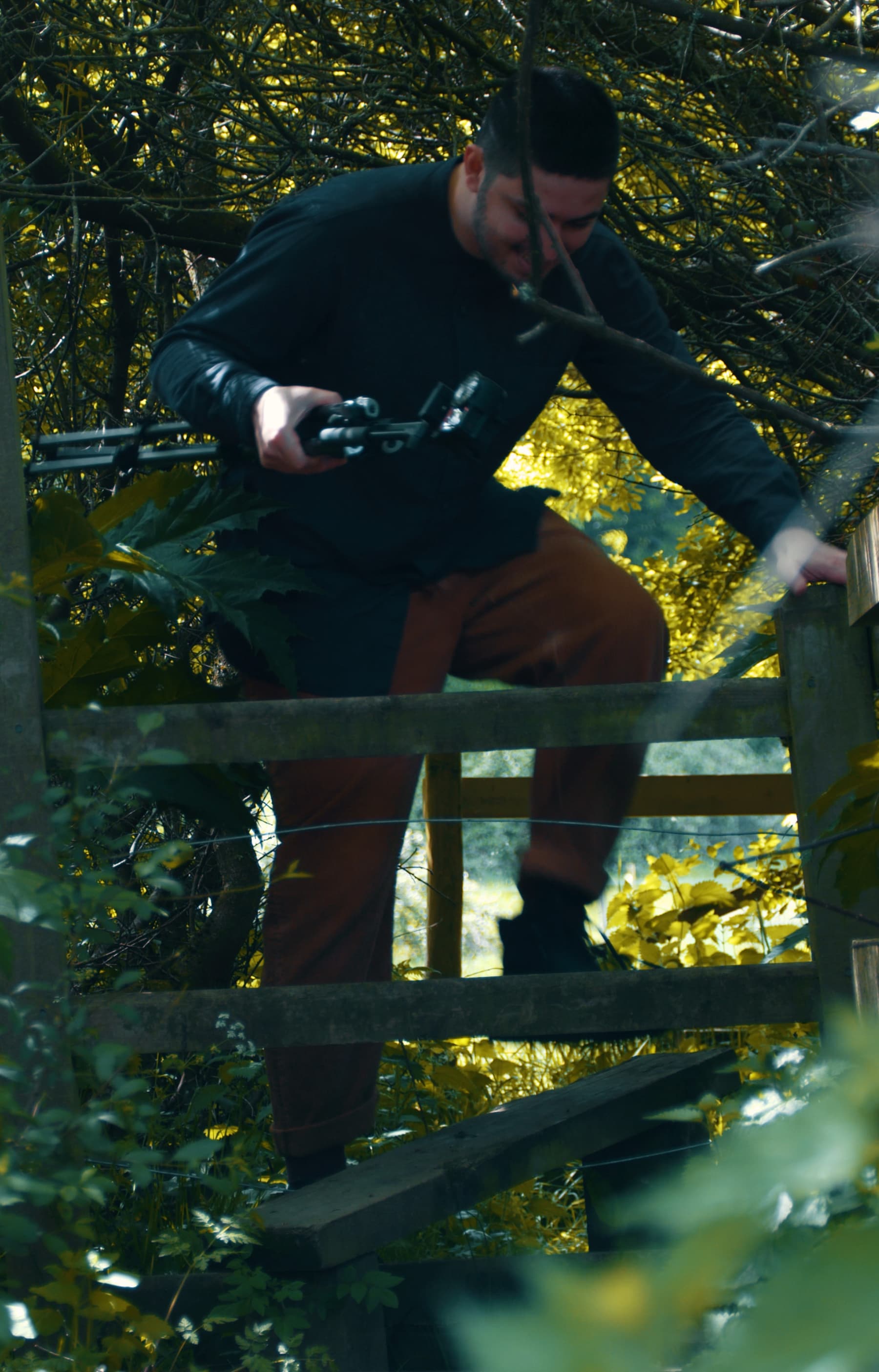 Joe climbs over a stile.